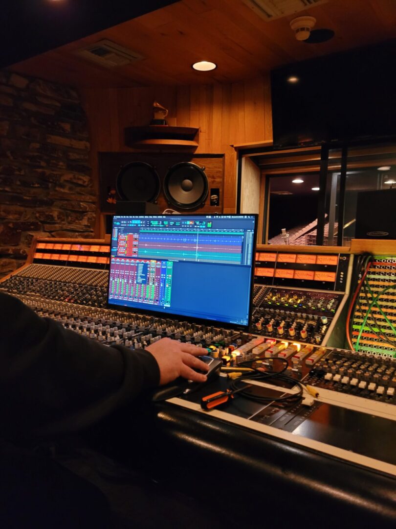 A person sitting and working in a music studio.