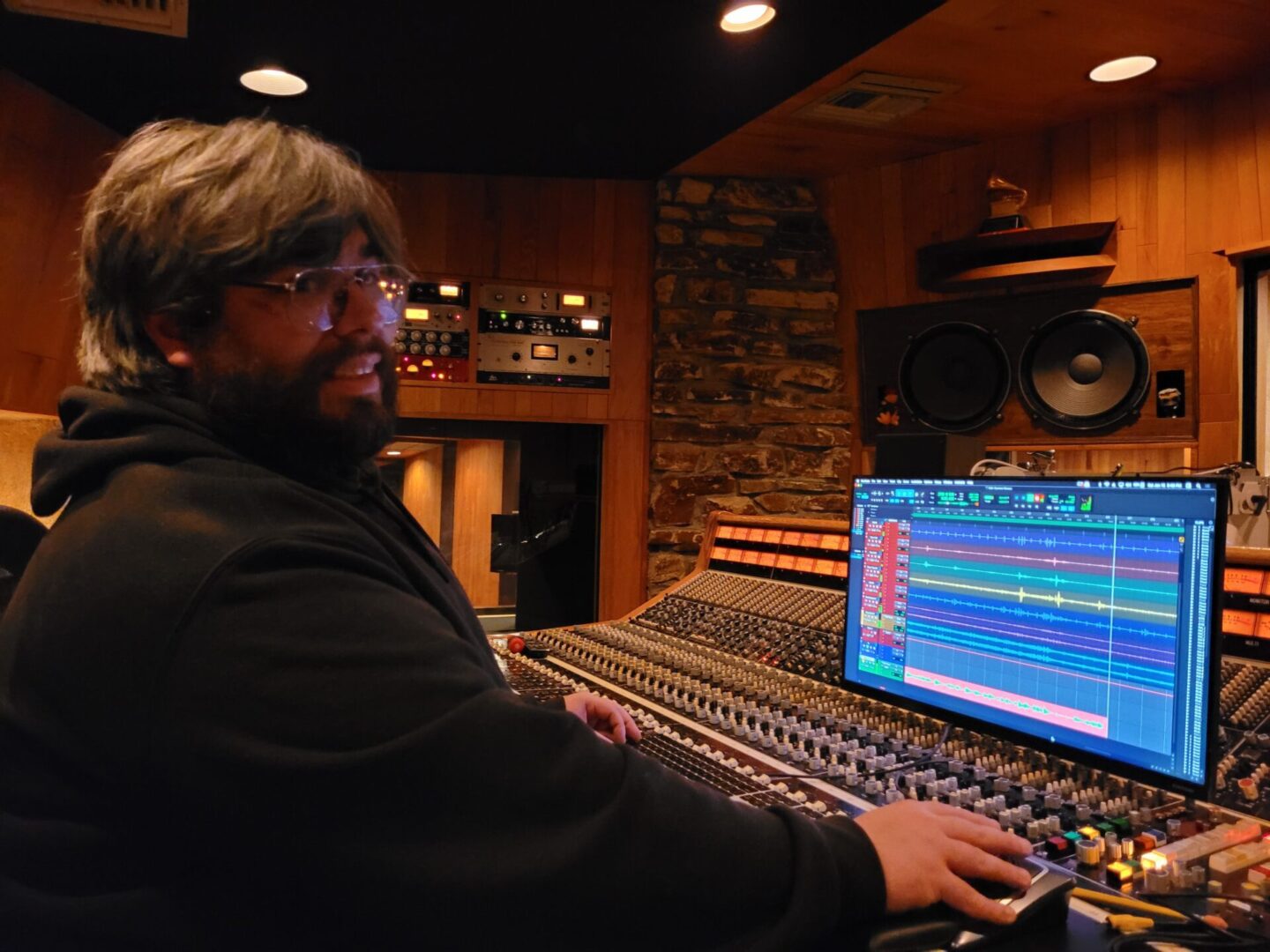 A person sitting and working in a music studio.